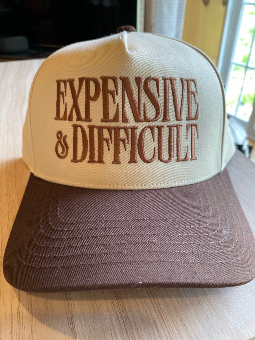 Brown expensive & difficult trucker hat